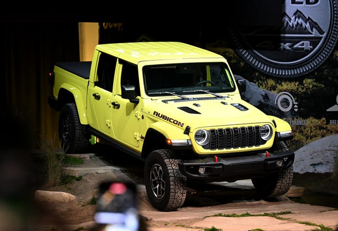 The 2024 Jeep Gladiator drives onto the stage during the reveal at Huntington Place in Detroit on Sept. 13, 2023. \