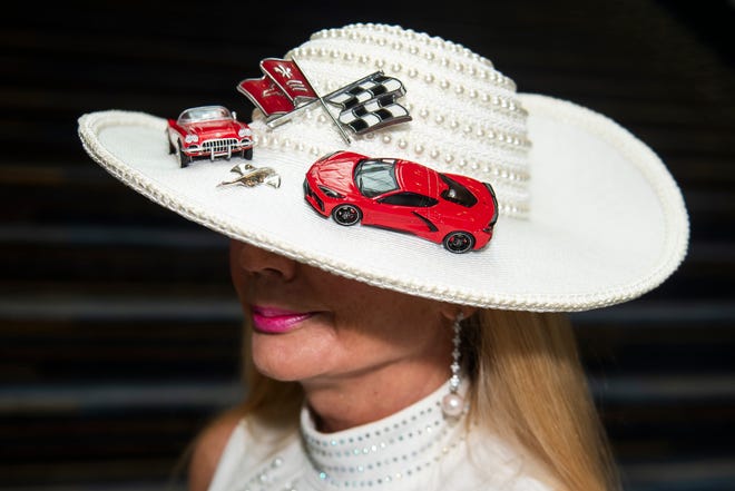 Ava Sand of Royal Oak poses for a photo, showing off her custom hat, before a ribbon cutting ceremony during the Detroit Auto Show Charity Preview Gala on Friday, Sept. 15, 2023 at Huntington Place in downtown Detroit. (Katy Kildee/The Detroit News)