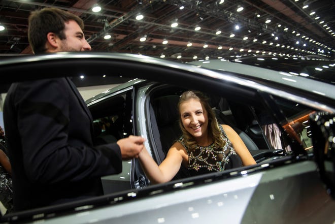 Megan McLellan of Allen Park gets help exiting a 2024 Cadillac XT6 from Kevin Rold of Livonia during the Detroit Auto Show Charity Preview Gala on Friday, Sept. 15, 2023 at Huntington Place in downtown Detroit. (Katy Kildee/The Detroit News)