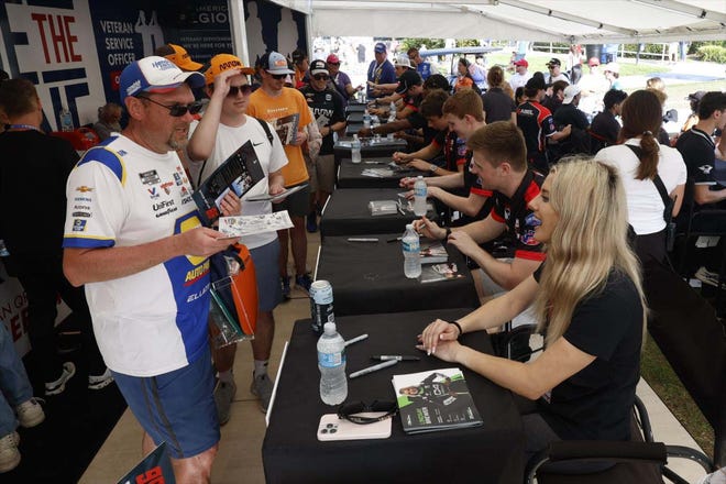 Indy NXT drivers sign autographs at St. Petersburg season opener.