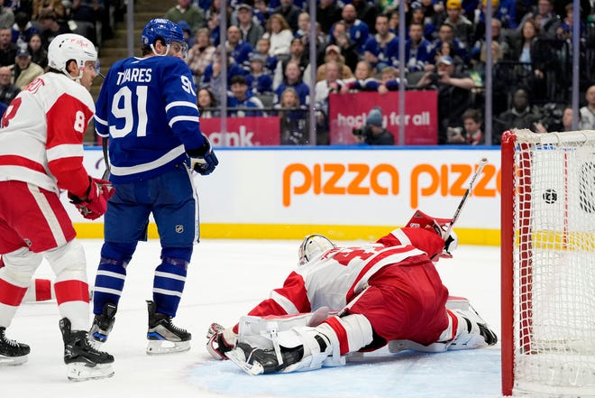 Maple Leafs center John Tavares (91) watches a goal by Auston Matthews fly past Red Wings goaltender James Reimer (47) during the second period.