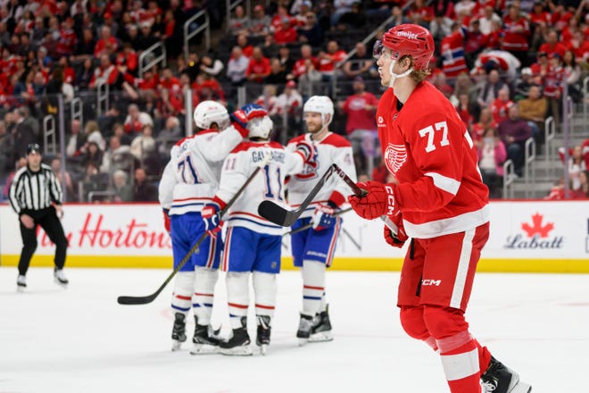 Detroit defenseman Simon Edvinsson skates past the Canadiens celebrating a goal by right wing Brendan Gallagher during the second period.