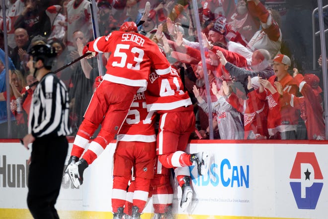 The Red Wings celebrate after left wing Lucas Raymond scored the game winning goal during the overtime period.