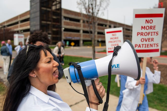 Dr. Romajit Yatooma leads a group of physicians and physician assistants from the Ascension St. John Emergency Department in a chant as they begin a 24-hour strike on Thursday, April 18, 2024 at the hospital in Detroit.