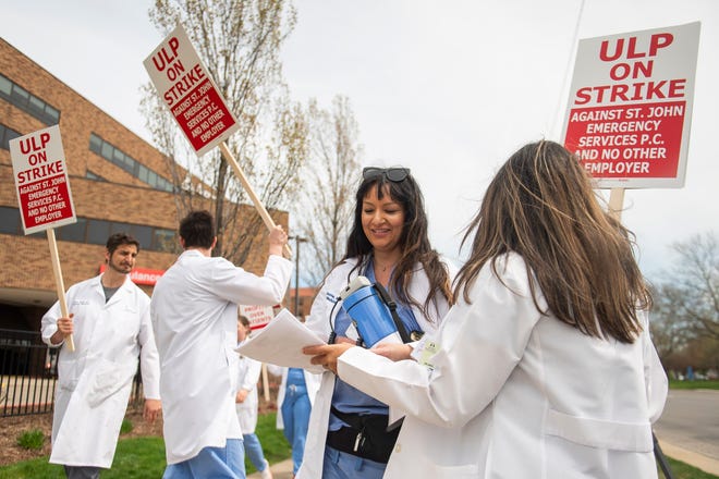 Dr. Romajit Yatooma, center, chats with a colleague as physicians and physician assistants from the Ascension St. John Emergency Department begin a 24-hour strike on Thursday, April 18, 2024 at the hospital in Detroit.