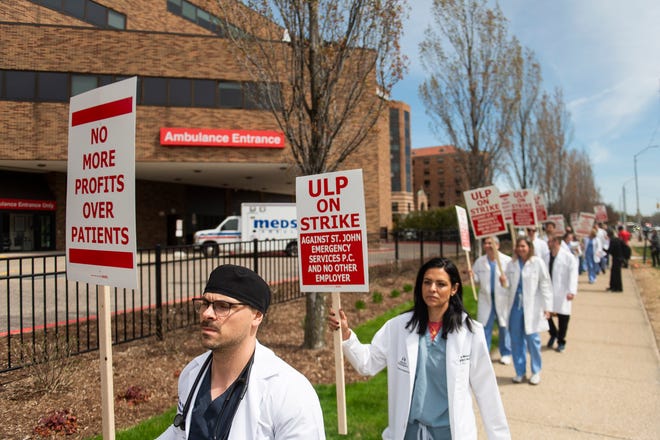 Physician assistant Nicholas Sadowski, left, pickets alongside fellow physicians and physician assistants from the Ascension St. John Emergency Department as they begin a 24-hour strike on Thursday, April 18, 2024 at the hospital in Detroit.