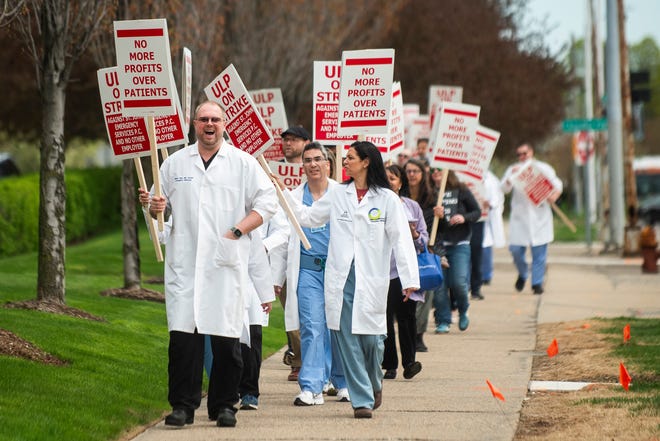 Dr. Shaun Gray, left, pickets alongside fellow physicians and physician assistants from the Ascension St. John Emergency Department as they begin a 24-hour strike on Thursday, April 18, 2024 at the hospital in Detroit.