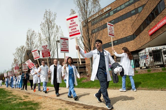 Physician assistant Nicholas Sadowski, right, pickets alongside fellow physicians and physician assistants from the Ascension St. John Emergency Department as they begin a 24-hour strike on Thursday, April 18, 2024 at the hospital in Detroit.