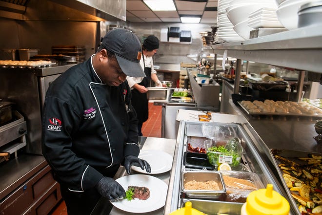 Omar Mitchell, executive chef at Table No. 2, an upscale restaurant in Detroit's Greektown, plates a cut of steak on Thursday, April 18, 2024.