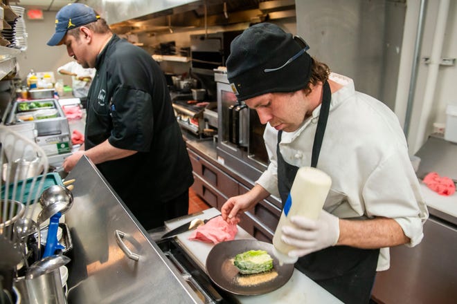 John Jaime, second executive chef at Table No. 2, an upscale restaurant in Detroit's Greektown, left, and garde chef Alex Davis, right, work in the kitchen on Thursday, April 18, 2024.