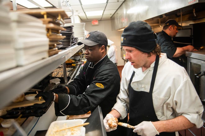 Omar Mitchell, executive chef at Table No. 2, an upscale restaurant in Detroit's Greektown, left, and garde chef Alex Davis, right, work in the kitchen on Thursday, April 18, 2024.