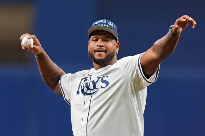 Tampa Bay Buccaneers defensive end William Gholston throws out the ceremonial first pitch before a baseball game between the Tampa Bay Rays and the Detroit Tigers Monday, April 22, 2024, in St. Petersburg, Fla.