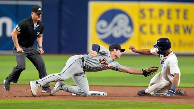 Detroit Tigers second baseman Colt Keith, center, tags out Tampa Bay Rays' Amed Rosario, right, attempting to steal second base during the first inning.
