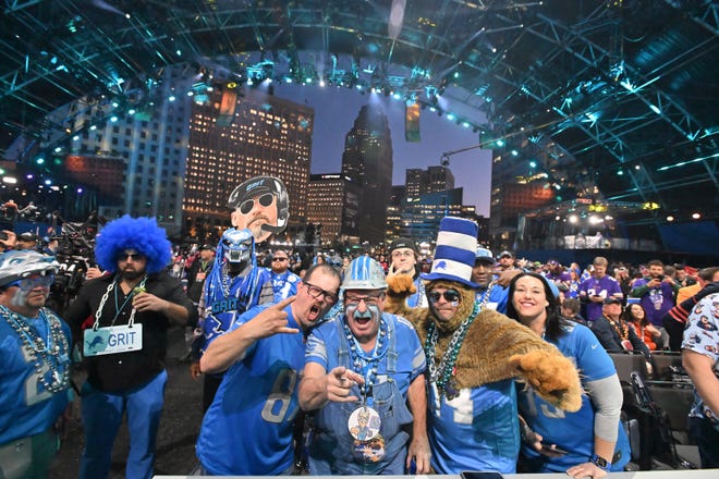 Detroit Lions fans in the front row cheer during the 2024 NFL Draft in Detroit on April 25, 2024.