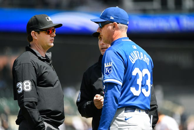 Royals manager Matt Quatraro, right, talks with first base umpire Adam Beck, left, and second base umpire Dan Iassogna in the fourth inning.