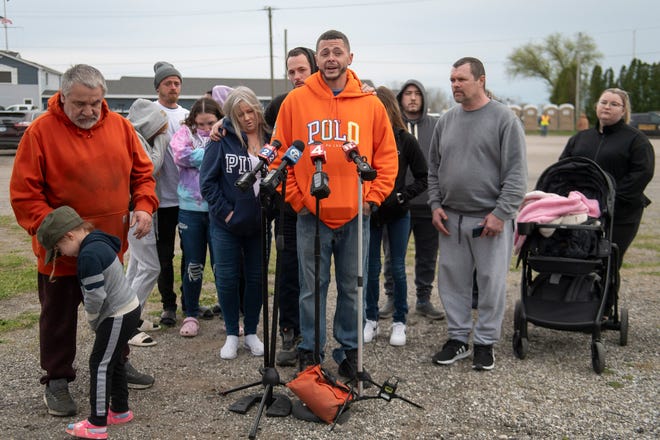 Michael Hatfield, center, expresses his grief while speaking to the press about his niece and nephew, Alanah Phillips, 8, and Zayn Phillips, 4, before a vigil in their honor on Friday, April 26, 2024, at the Swan Boat Club in Newport, Michigan.