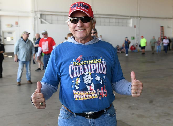 Farmer Dick Kleinhardt, 76, of Clare shows off his shirt before the Donald Trump rally at MBS International Airport in Freeland, Mich. on May 1, 2024.