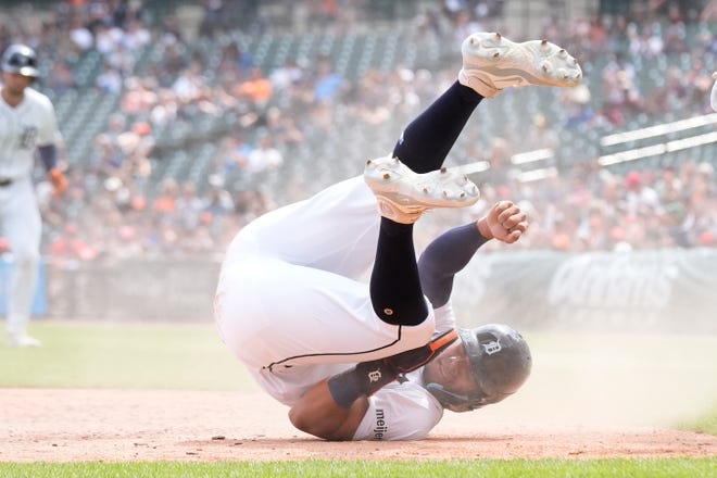 Tigers' Wenceel Pérez flips after beating the throw to Cardinals catcher Willson Contreras to score during the eighth inning.