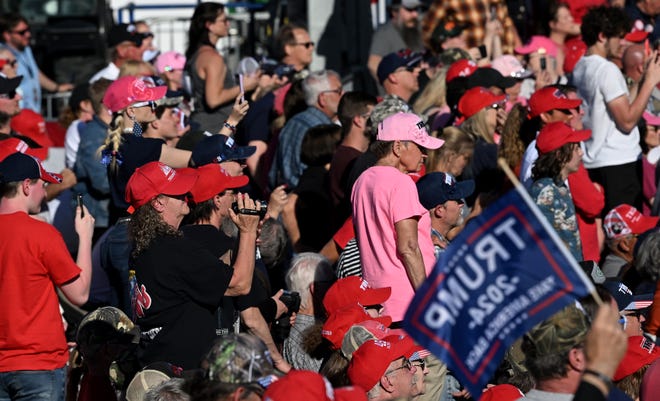 Supporters watch and listen as Donald Trump speaks at his rally at MBS International Airport in Freeland, Mich. on May 1, 2024.