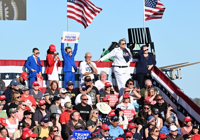 Trump supporters listen as Donald Trump speaks at his rally at MBS International Airport in Freeland, Mich. on May 1, 2024.