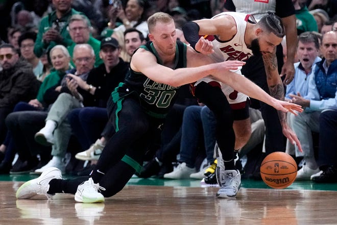 Celtics forward Sam Hauser (30) battles Heat forward Caleb Martin for the ball during the first half of Game 5 in the first-round playoff series on Wednesday in Boston.