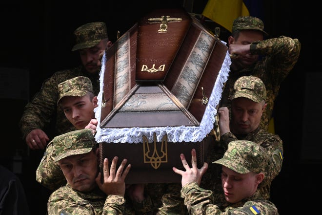 Ukrainian soldiers carry the coffin of Ukrainian serviceman Taras Osmyakevych, who was killed in action, during a funeral ceremony in Lviv on May 2, 2024, amid the Russian invasion of Ukraine.