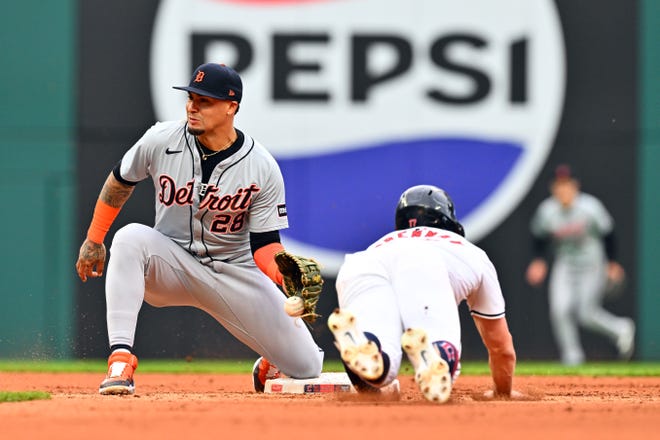 Shortstop Javier Baez #28 of the Detroit Tigers catches Will Brennan #17 of the Cleveland Guardians stealing second during the fourth inning.