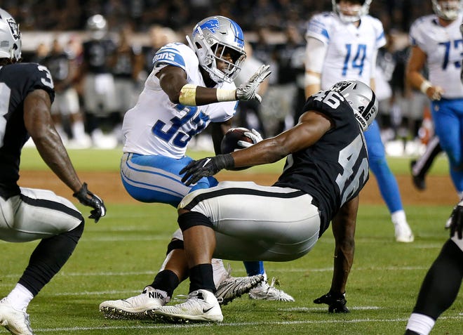 Detroit Lions running back Kerryon Johnson (33) carries as Oakland Raiders linebacker Jason Cabinda defends during the second half.