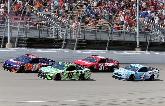 Kyle Busch (18), Denny Hamlin (11), Ryan Newman (31) and Kevin Harvick (4) race during the NASCAR Cup Series Consumers Energy 400 at Michigan International Speedway.