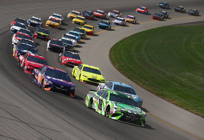 Kyle Busch, driver of the No. 18 Toyota, and Kevin Harvick, driver of the No. 4 Mobil 1 Ford, lead the field during the NASCAR Cup Series Consumers Energy 400 at Michigan International Speedway.