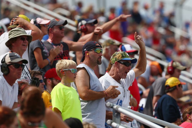 Fans cheer during the NASCAR Cup Series Consumers Energy 400 at Michigan International Speedway.