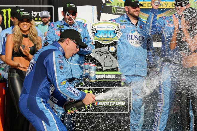 Kevin Harvickn celebrates in Victory Lane after winning the NASCAR Cup Series Consumers Energy 400 at Michigan International Speedway.