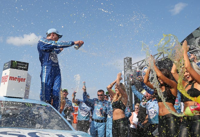 Kevin Harvick celebrates in Victory Lane after winning the NASCAR Cup Series Consumers Energy 400 at Michigan International Speedway.