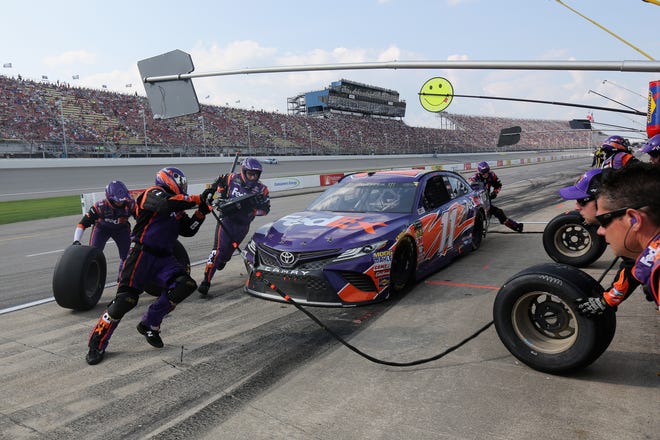 Denny Hamlin pits during the NASCAR Cup Series Consumers Energy 400 at Michigan International Speedway.