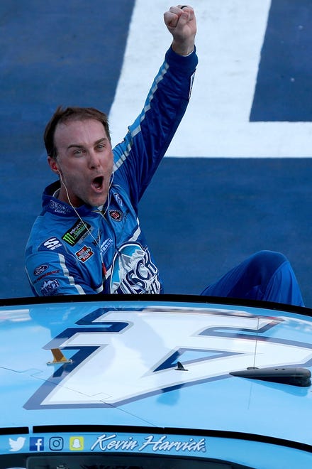 Kevin Harvick celebrates after winning the NASCAR Cup Series Consumers Energy 400 at Michigan International Speedway.