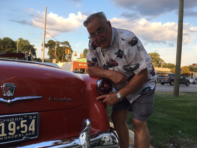 Bill Haas of South Lyon was rear-ended 15 years ago as he was driving his 1954 Ford Sunliner convertible to be displayed at the Glass House in Dearborn. The filler from the repair is beginning to crack.