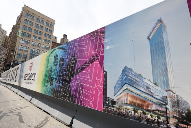 A rendering of the residential tower and mixed use building that will be constructed on the Hudson's site adorns Bedrock's sign at Woodward at Gratiot.