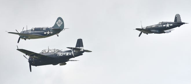 A Curtiss SB2C Helldiver dive bomber, top-left, and a Grumman TBF Avenger torpedo bomber, bottom-left, are followed by a Vought F4U Corsair fighter aircraft.
