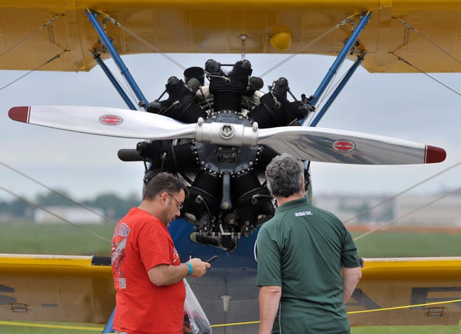 Two men, who wish not to be identified, look at the prop and 220 horsepower engine on this 1944 Boeing Stearman PT 17 bi-plane used to train pilots during WWII. The engines were built in Muskegon.