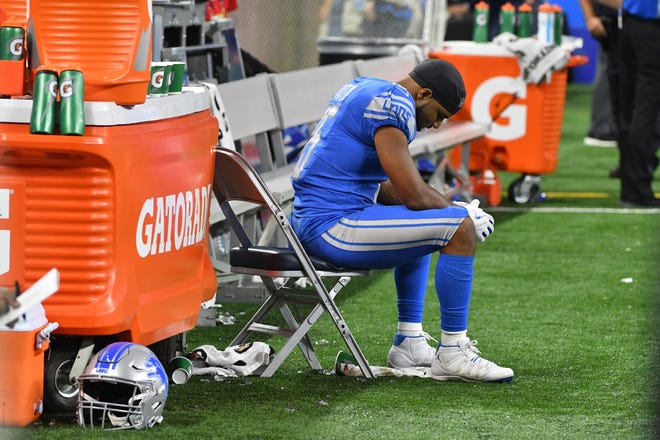 Lions receiver Golden Tate sits on the sidelines late in the fourth quarter during the team's season opener against the New York Jets.
