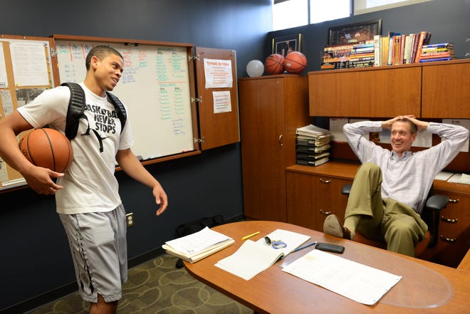 Jay Smith sits in his office in 2014 during his time at Detroit Mercy, talking with former Titan star Ray McCallum Jr.