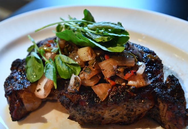 A  28 day dry aged ribeye, charred onion relish, watercress and olive oil.