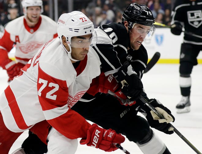 Detroit Red Wings' Andreas Athanasiou (72) is defended by Los Angeles Kings' Tanner Pearson (70) during the first period of an NHL hockey game Sunday, Oct. 7, 2018, in Los Angeles. (AP Photo/Marcio Jose Sanchez)