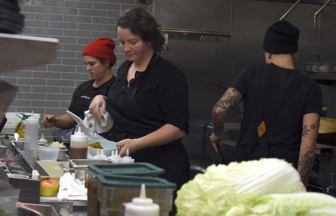 Line cook Emma Tocco, left, and executive chef Sarah Welch, center, prepare dishes. In a male-dominated business, Welch is proud to have an all-female staff.