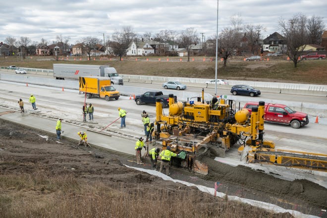 Construction workers pour concrete on I-75 near Livernois in Detroit, December 17, 2018.  Heaters are used to keep fresh concrete from freezing and cracking in cold temperatures.