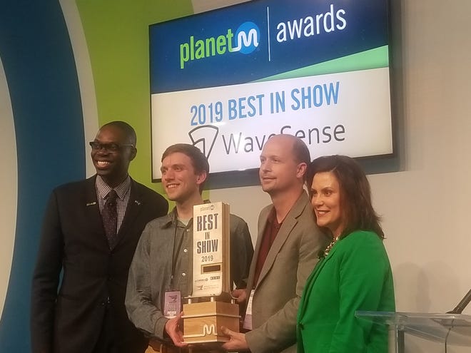 Gov. Gretchen Whitner and Lt. Gov. Garlin Gilchrist, left, award WaveSense Chief Technology Officer Byron Stanley, second from right, the best in show award at PlanetM's second annual awards during the North American International Auto Show.