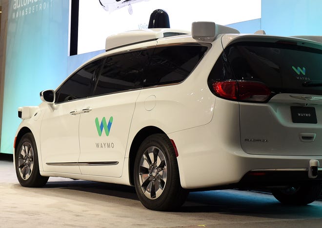 A Chrysler Pacifica is outfitted with Waymo LLC's self-driving system. The Google spinoff says it will invest up to $13.6 million in a facility in Detroit to integrate its technology into automaker partners' vehicles.