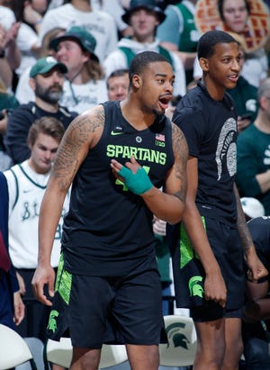 Michigan State's Nick Ward, his injured hand wrapped in tape, reacts on the bench during the second half of the Spartans' win.