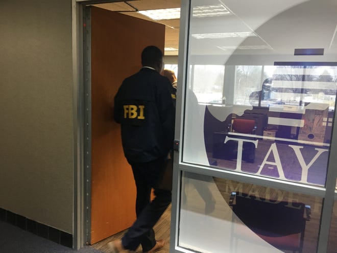 An FBI agent enters the Department of Development office at Taylor City Hall on Tuesday, Feb. 19, 2019.