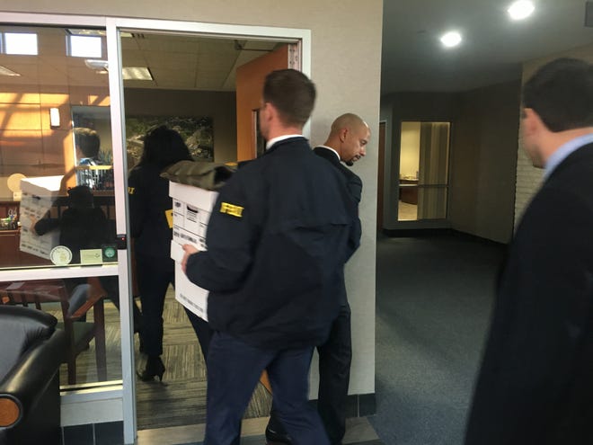 FBI agents carry boxes into Taylor Mayor Rick Sollars' office at City Hall on Tuesday, Feb. 19, 2019.